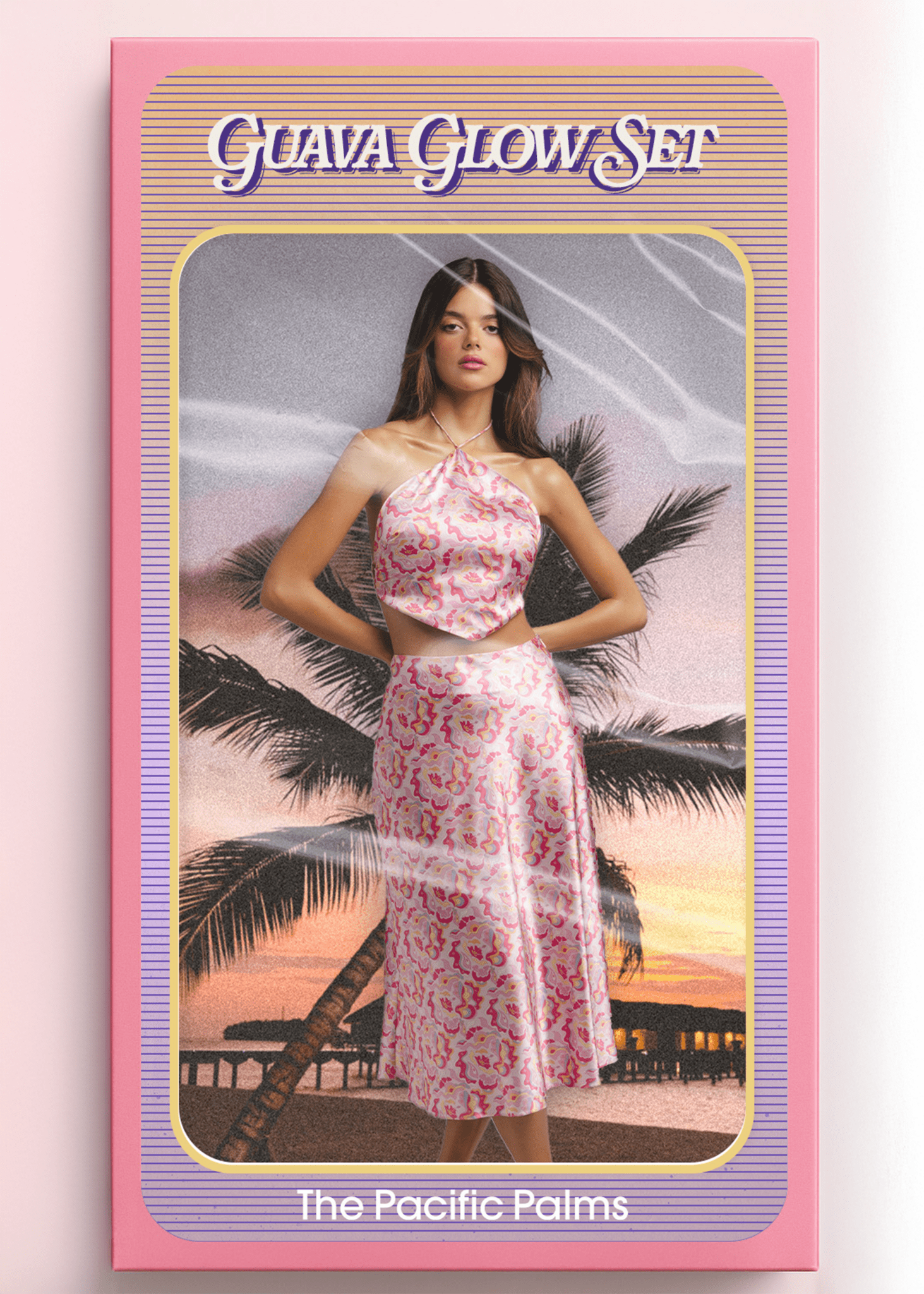 <img src="guavaglowset" alt="Guava Glow Set – The Pacific Palms. Model inside a vintage doll-style packaging box, wearing a pink satin retro pattern co-ord outfit holding an orange woven bag. Styled like a retro toy against a sunset beach with palm trees and overwater bungalows.">