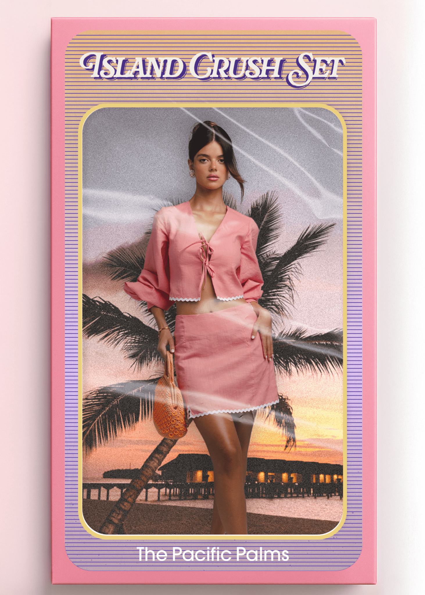 <img src="islandcrushset" alt="Island Crush Set – The Pacific Palms. Model  inside a vintage doll-style packaging box, wearing a pink co-ord outfit with white trim and holding an orange woven bag. Styled like a retro toy against a sunset beach with palm trees and overwater bungalows.">