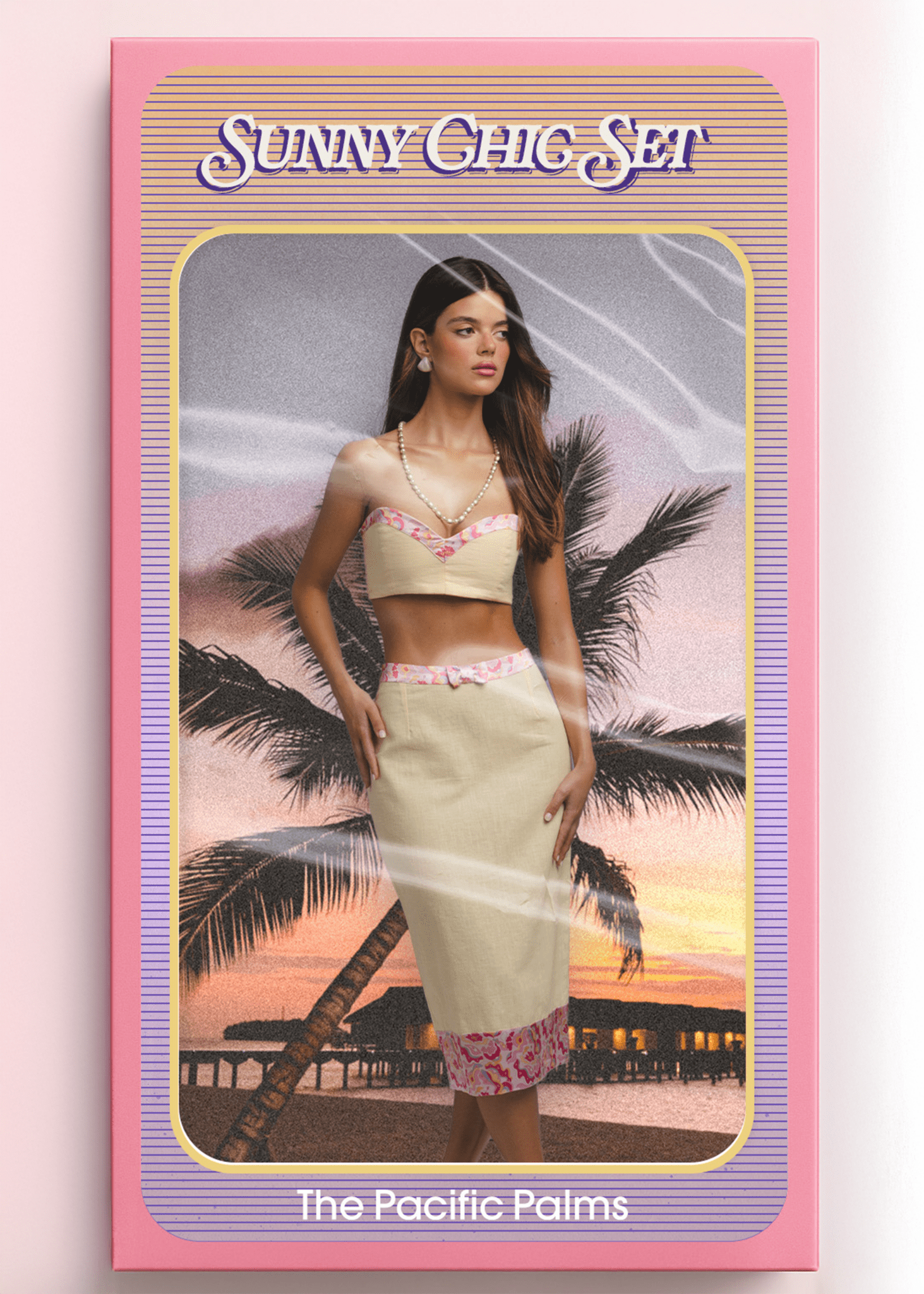 <img src="sunnychicset" alt="Sunny Chic Set – The Pacific Palms. Model inside a vintage doll-style packaging box, wearing a yellow co-ord outfit with a retro pattern hem and front bow. Styled like a retro toy against a sunset beach with palm trees and overwater bungalows.">